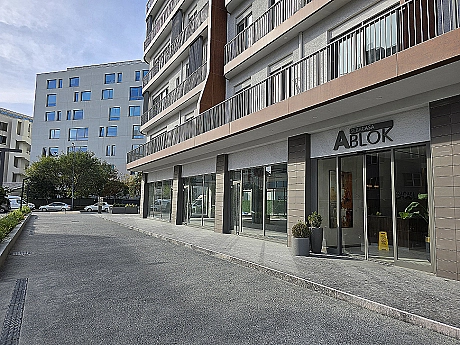 Exterior of a modern building with large windows and balconies.