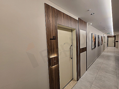 Modern apartment entrance hall, white walls, wood details