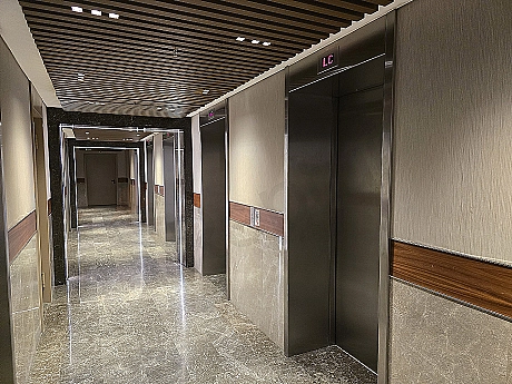 Modern elevator cabin interior with stainless steel details and lighting