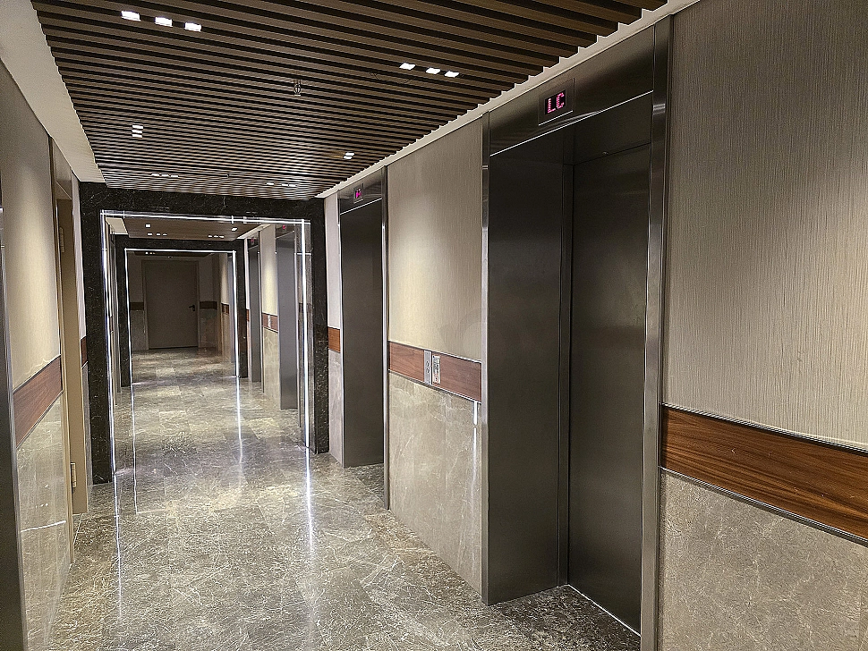 Modern elevator cabin interior with stainless steel details and lighting