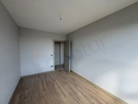 Spacious and modern interior view of a bright bedroom in a luxury apartment.