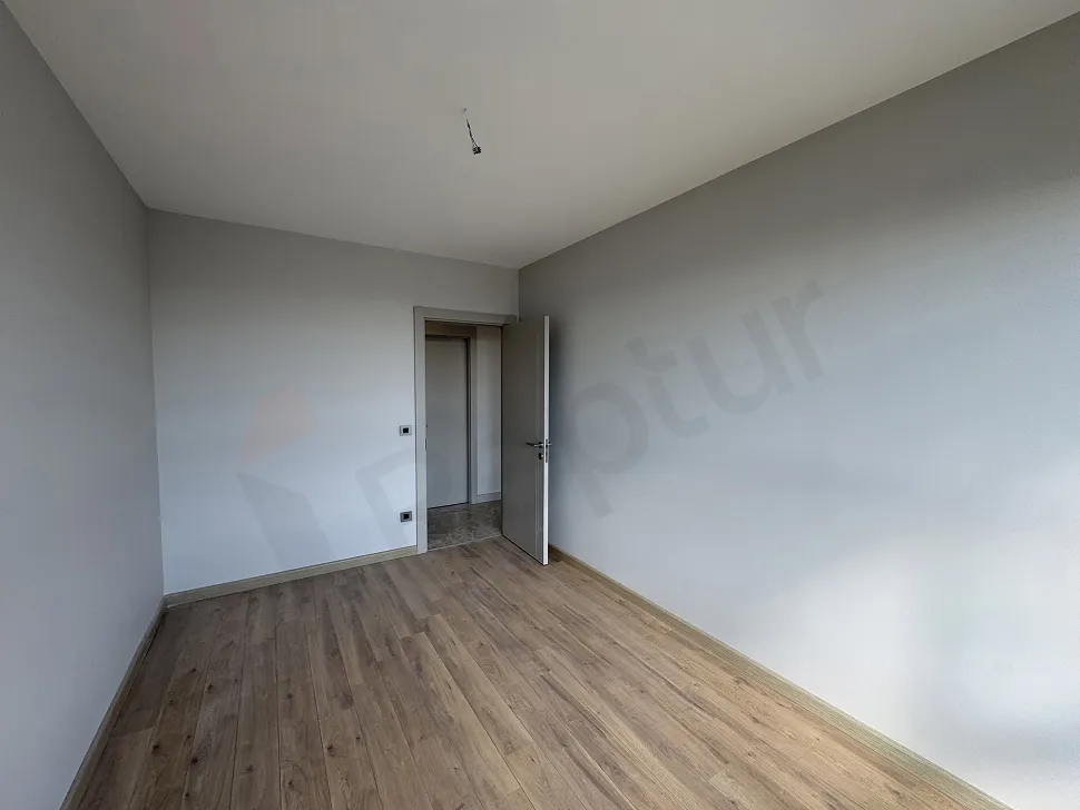 Spacious and modern interior view of a bright bedroom in a luxury apartment.