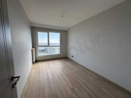 Bright and spacious bedroom interior of a modern apartment.