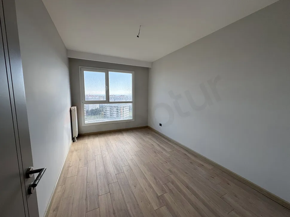 Bright and spacious bedroom interior of a modern apartment.