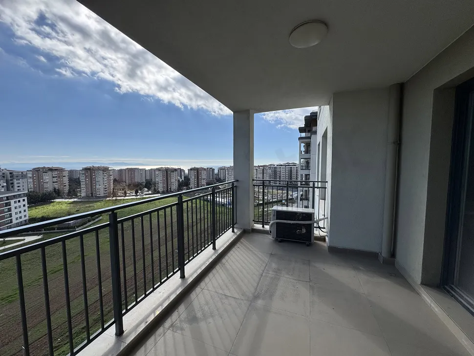 Spacious and airy apartment balcony with a modern design in a new building.