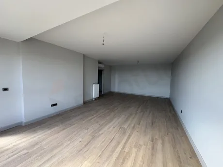 A spacious and bright living room area with modern architecture and large windows.