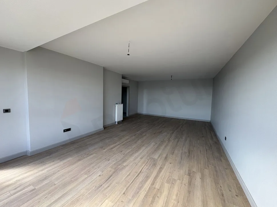A spacious and bright living room area with modern architecture and large windows.
