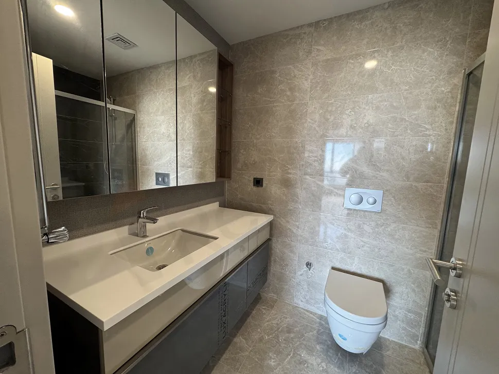 Interior view of a spacious and bright bathroom decorated with modern and stylish ceramics.