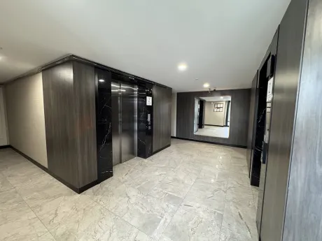 A modern and spacious luxury apartment building lobby.