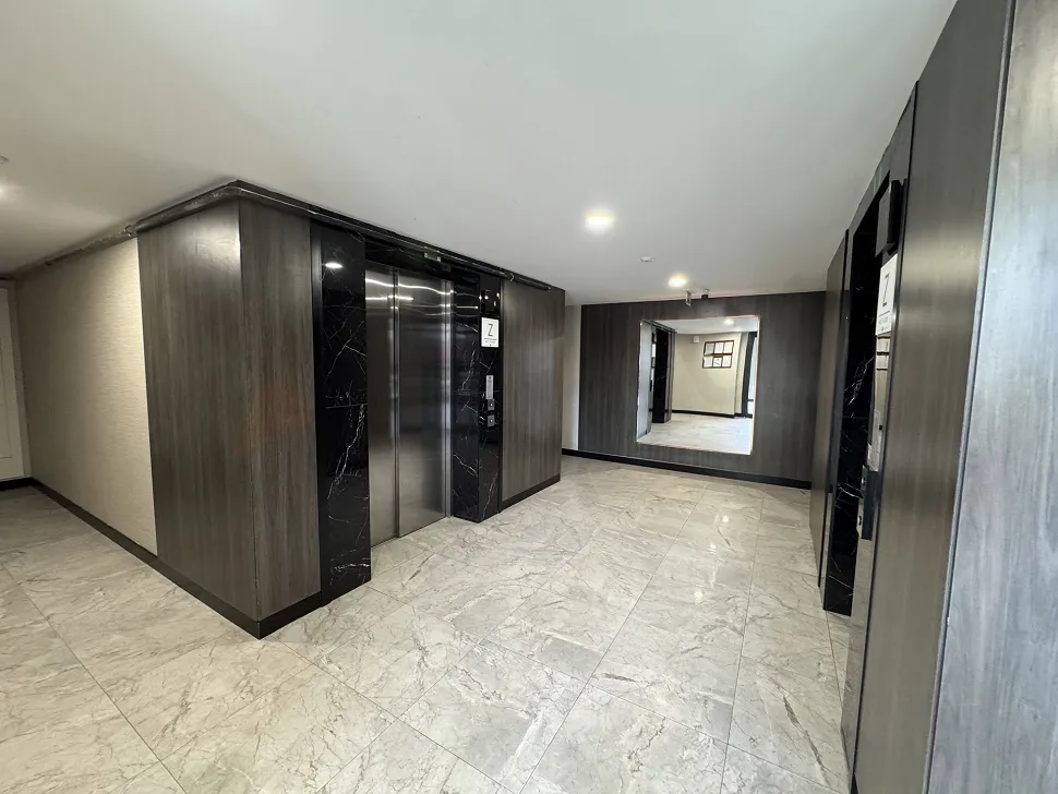 A modern and spacious luxury apartment building lobby.