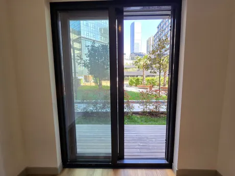 A spacious and airy balcony area with modern railings overlooking the city view.