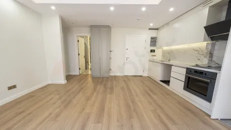 A bright and spacious living room area with modern architectural lines and large windows.