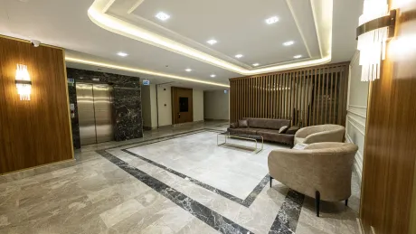 Spacious and brightly lit lobby area of a modern and stylishly designed residence.