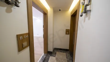 Entrance door and hallway area of a new 1+1 apartment in a modern building.