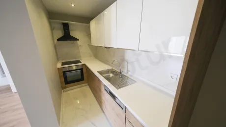 Modern kitchen area with spacious countertops and functional kitchen cabinets.