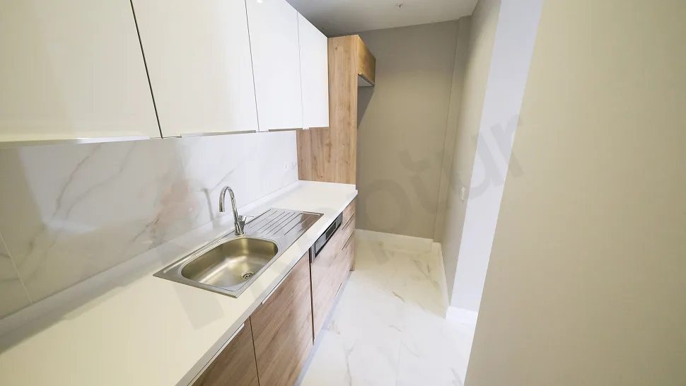 Modernly designed apartment kitchen with spacious countertops and cabinets in Başakşehir.