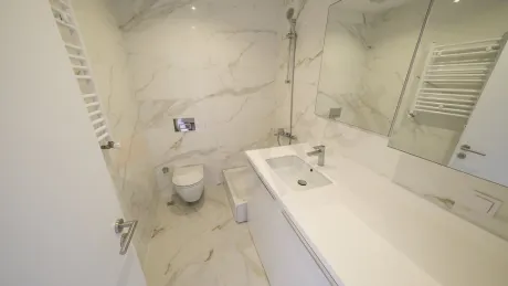 Modern designed bathroom interior with sink, mirror, and faucet details.
