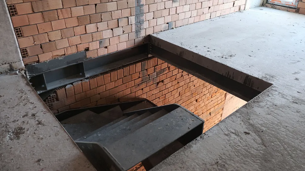 Internal staircase with a modern architectural design inside a commercial shop.