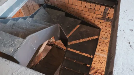 Modern internal staircase design providing access between floors inside a commercial shop unit.