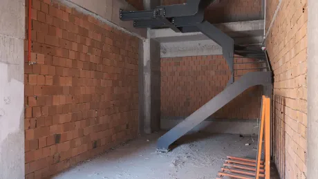 Modern design interior staircase and steps connecting two floors inside a commercial shop.