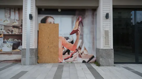 View of an apartment entrance door and hallway inside a modern building.