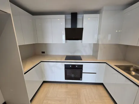 Modern kitchen view with spacious cabinets and stylish countertop details.