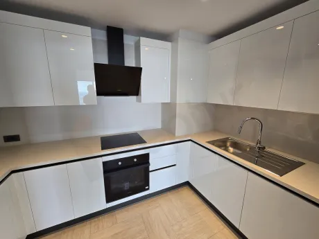 Kitchen area of a luxury apartment with a modern and spacious design.