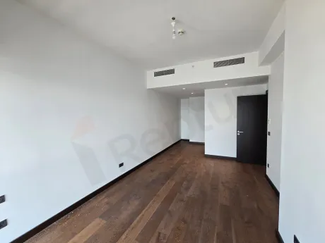 Spacious and bright bedroom area with large windows and city views in a modern residence in Sisli.