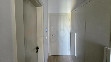 View of the entrance door and hallway of a modern apartment.