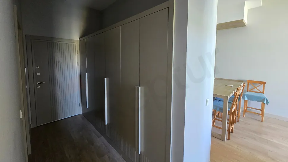 Spacious and bright corridor view of a modern apartment.