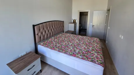 View of a bright and modern bedroom with large windows.