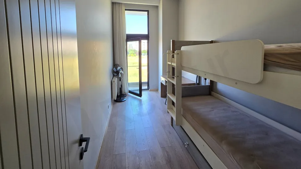 View of a spacious and modern balcony of an apartment.