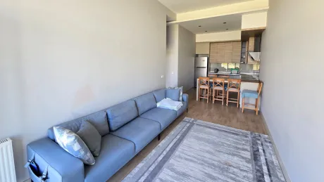 Bright living room with large windows, spacious layout, and modern architectural details.