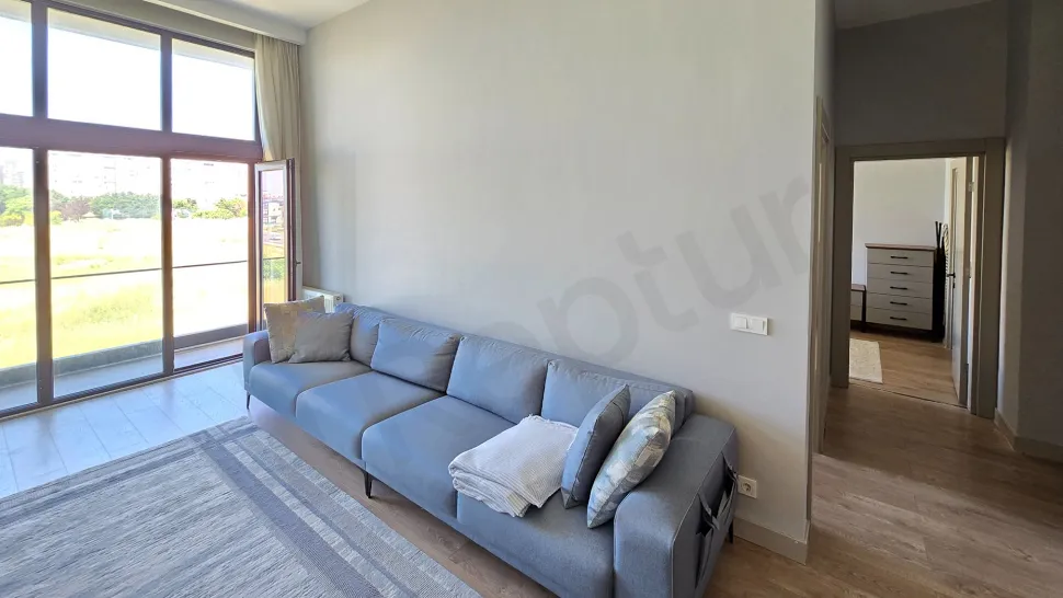 A view of a modern, spacious, and bright living room in a 2+1 apartment in Beylikdüzü.