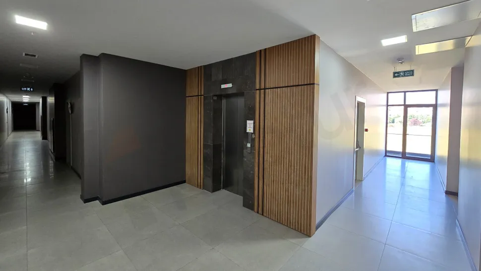 Sleek and modern interior design of an elevator cabin and door in a residential building.