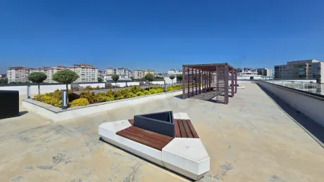 Spacious and empty terrace area of a modern building overlooking the city view.