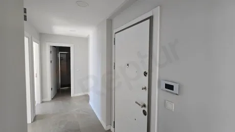Stylish and bright apartment entrance door and hallway area in a modern building.