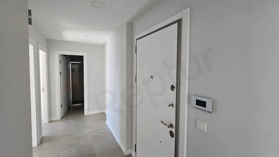 Stylish and bright apartment entrance door and hallway area in a modern building.