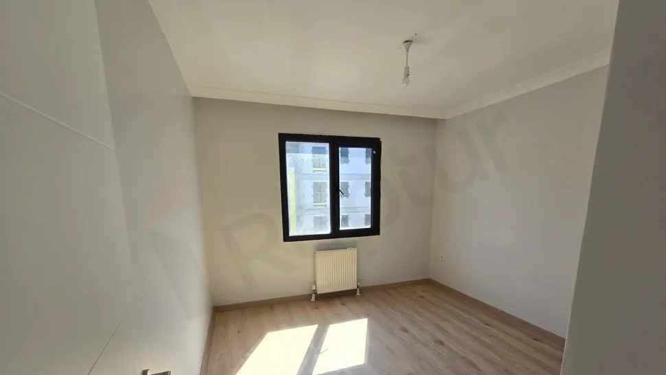 Spacious and bright bedroom area of a modern apartment.