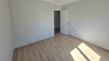Interior view of a spacious and bright empty bedroom in a 2+1 apartment for sale in Kucukcekmece, Istanbul.