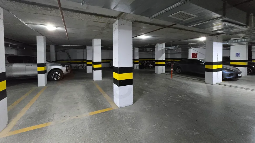 Spacious and secure indoor parking garage area of a modern building