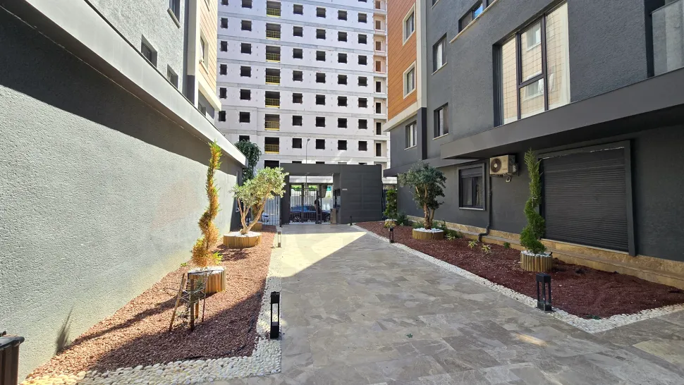 Landscaped spacious green garden of a modern residential complex in Kucukcekmece.