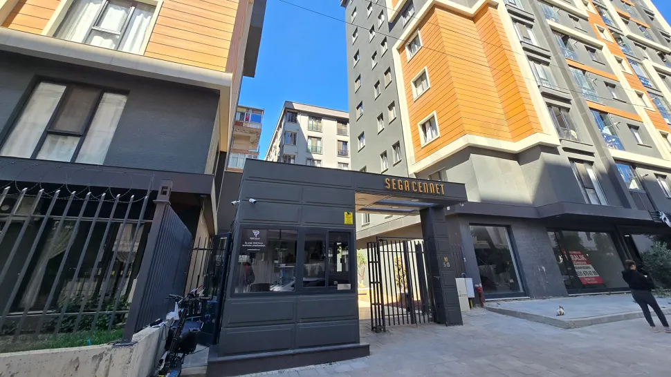 Security gate and checkpoint at the entrance of a modern residential complex.