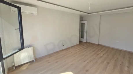 A bright and spacious living room area with large windows.