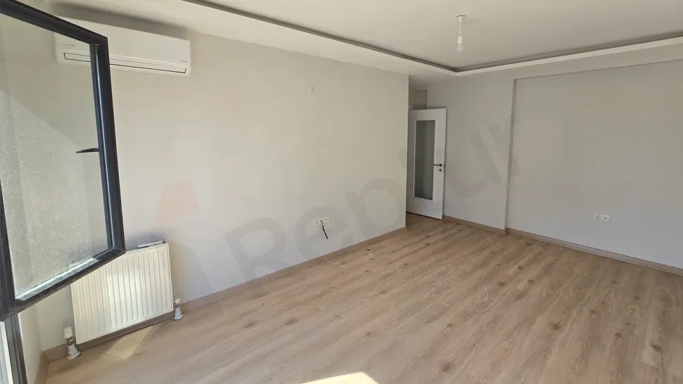 A bright and spacious living room area with large windows.