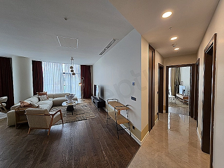 Stylish and modern living room design with comfortable sectional sofa, wood details and natural light.