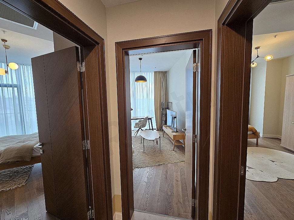 Interior photo of a modern, brightly lit, spacious, and luxurious corridor.