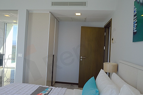 Modern bedroom interior featuring a bed and bedside tables.