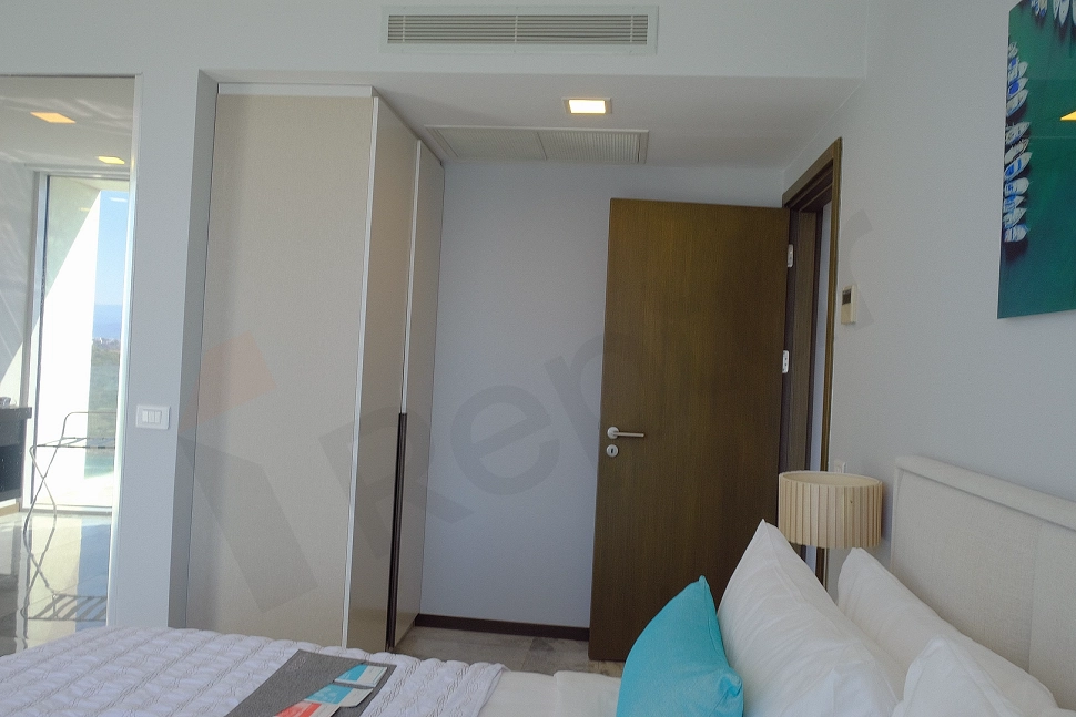 Modern bedroom interior featuring a bed and bedside tables.