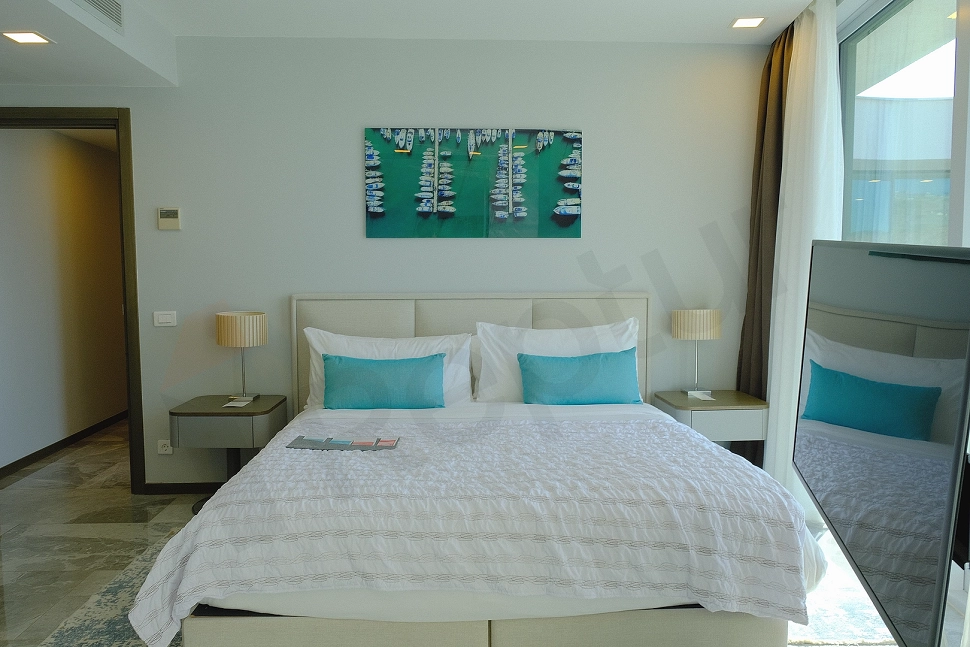 Tidy and comfortable bedroom with a bed and bedding set.